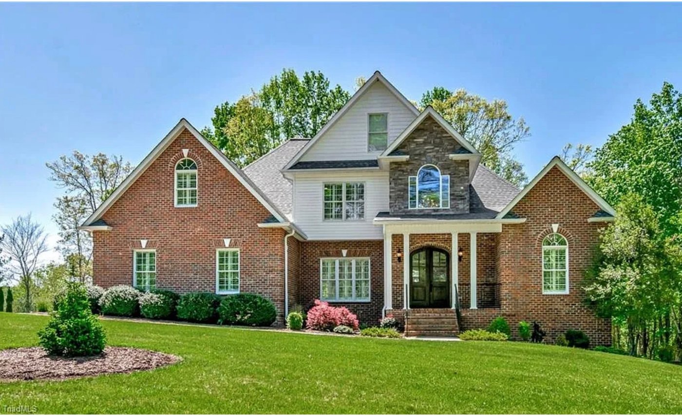 Beacon Ridge Wilkesboro NC luxury brick home exterior with stone accents, arched entry, and gabled rooflines